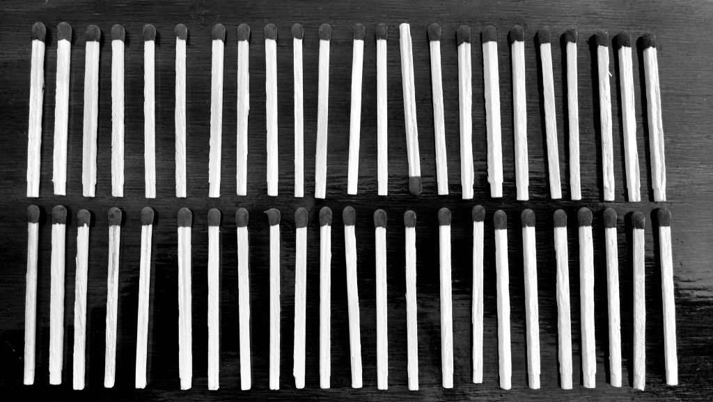 decorative image: matches lined up, one upside down