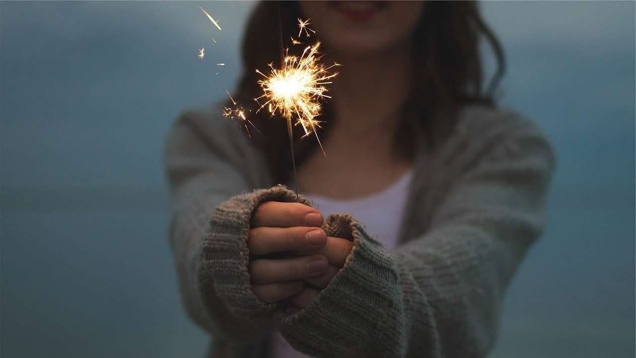 decorative image: woman holding sparkler