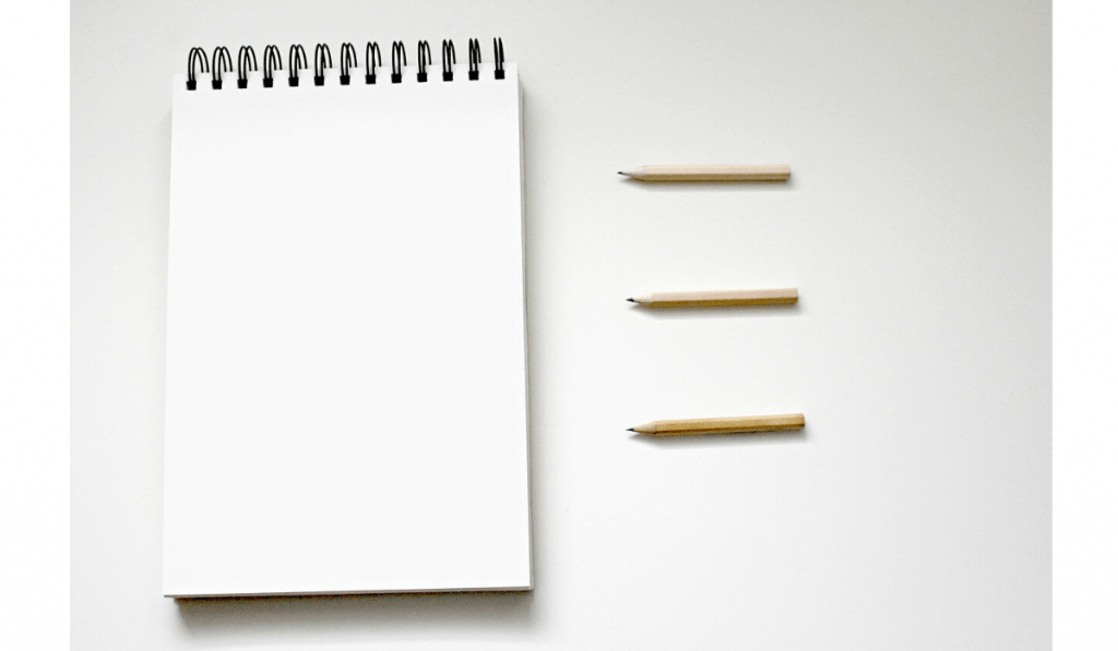 decorative image: notepad and pencils